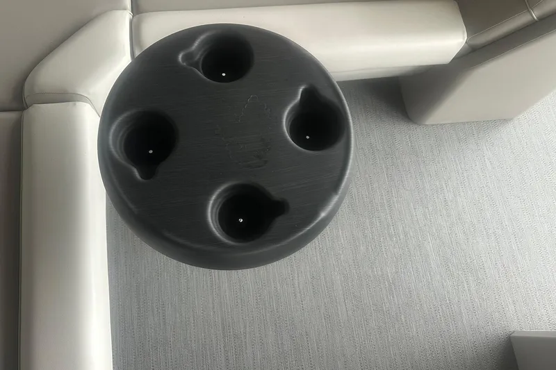 Slide: The Image of Round black cup holder on Sweetwater 2286FX boat, 2026 model, with beige seating. - 24