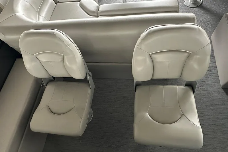 Slide: The Image of 2026 Sweetwater 2286FX boat interior with two beige cushioned seats. - 26