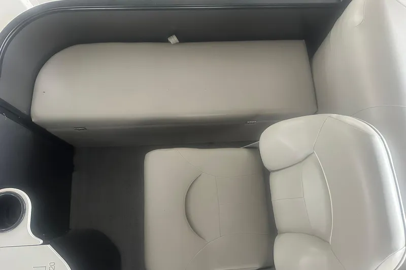 Slide: The Image of Interior seating of 2026 Sweetwater 2286FX boat with gray upholstery and cup holder. - 27