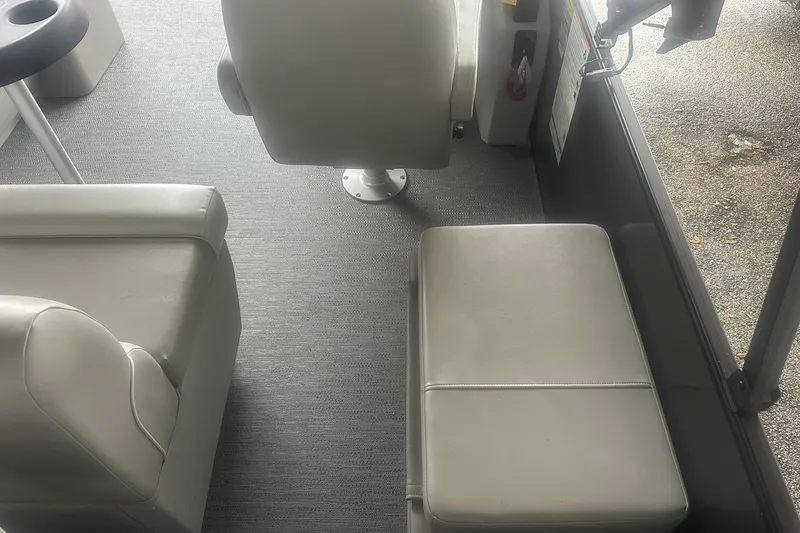Slide: The Image of Interior of 2026 Sweetwater 2286FX boat with beige seating and carpeted floor. - 28