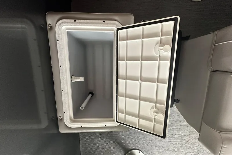 Slide: The Image of Open storage compartment on Sweetwater 2286FX boat, 2026 model, with white interior and lid. - 29