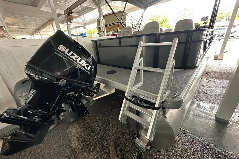 Slide: The Image of 2026 Sweetwater 2286FX pontoon boat with Suzuki outboard motor and ladder. - 31
