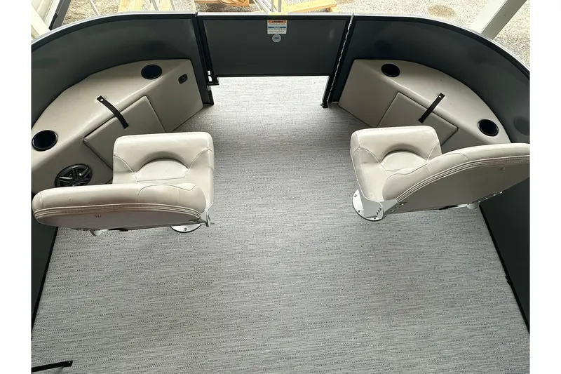 Slide: The Image of 2026 Sweetwater 2286FX boat interior with two swivel seats and cup holders. - 5