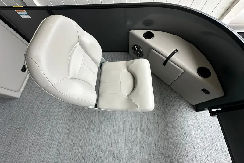 Slide: The Image of White seating area on a 2026 Sweetwater 2286FX boat interior. - 6