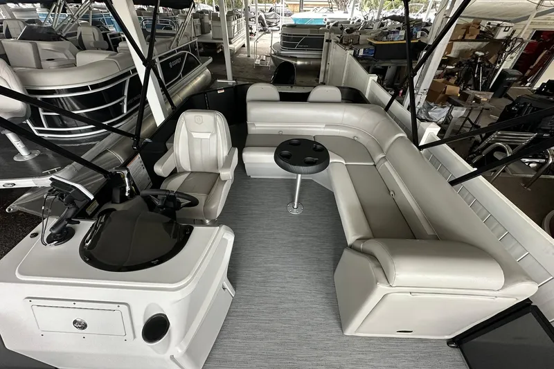 Slide: The Image of 2026 Sweetwater 2286FX pontoon boat interior with seating and helm station. - 9