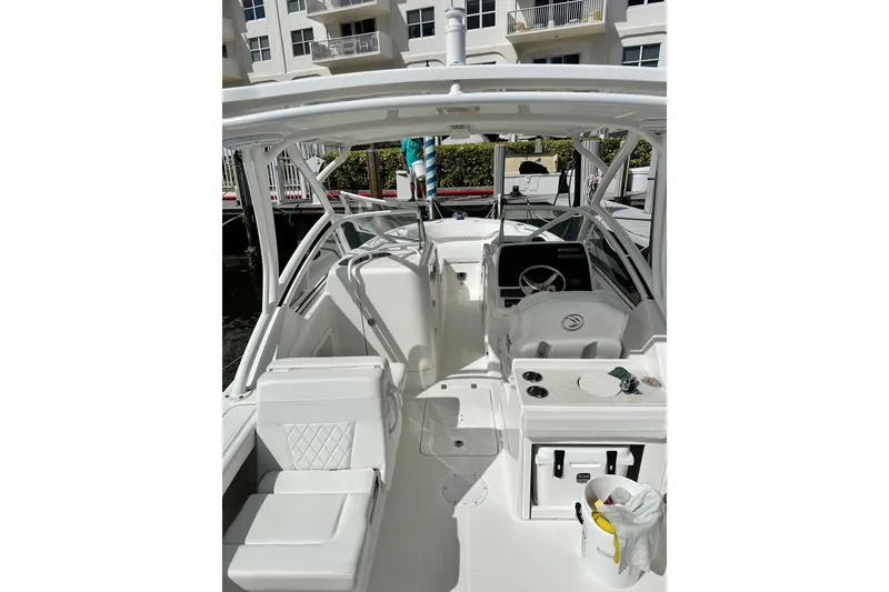 Slide: The Image of 2023 Edgewater 248CX Crossover boat interior with seating and steering console. - 3