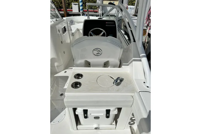 Slide: The Image of 2023 Edgewater 248CX Crossover boat interior with steering wheel and seating area. - 4