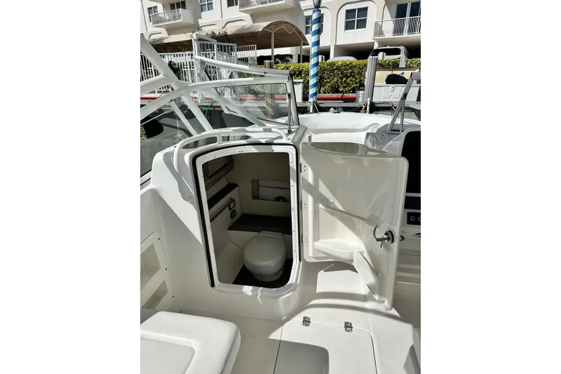 Slide: The Image of 2023 Edgewater 248CX Crossover boat interior with open cabin door. - 5