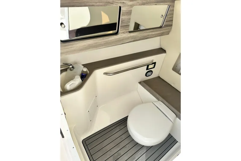 Slide: The Image of 2023 Edgewater 248CX Crossover boat bathroom with toilet, sink, and mirror. - 6