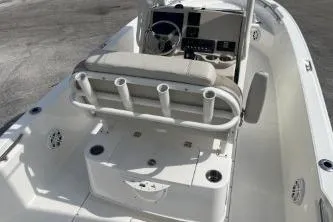 Slide: The Image of 2024 Boston Whaler 220 Dauntless boat interior with seating and console. - 12