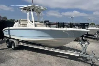 Slide: The Image of 2024 Boston Whaler 220 Dauntless boat on trailer, parked outdoors. - 3