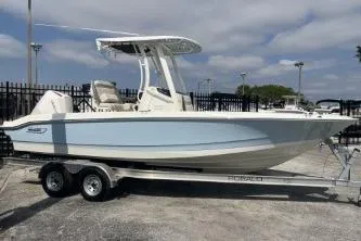 Slide: The Image of 2024 Boston Whaler 220 Dauntless boat on trailer, parked outdoors. - 4