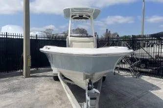 Slide: The Image of 2024 Boston Whaler 220 Dauntless boat on trailer, parked outdoors. - 5