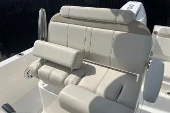 Slide: The Image of 2024 Boston Whaler 220 Dauntless boat seating, featuring comfortable beige upholstery. - 8