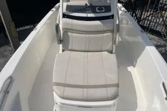 Slide: The Image of 2024 Boston Whaler 220 Dauntless boat interior with cushioned seating. - 9