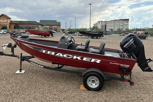 The Image of 2026 Tracker Super Guide V-16 SC boat on display in a dealership lot. - 0