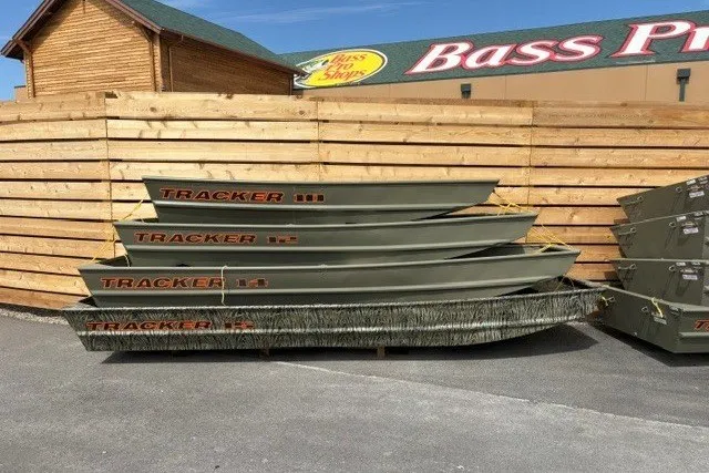 The Image of Stacked 2026 Tracker Grizzly 14 Jon boats outside Bass Pro Shops. - 0