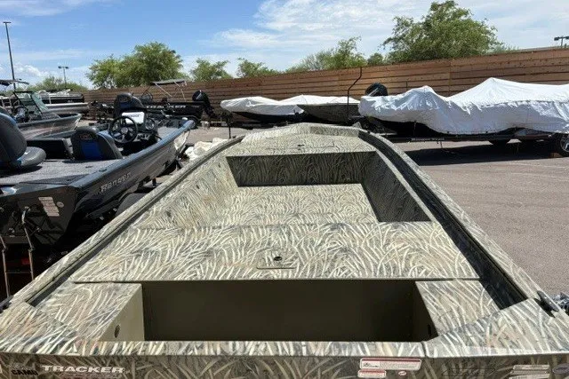 Slide: The Image of 2026 Tracker Grizzly 1648 Utility boat with camouflage design in outdoor showroom. - 18