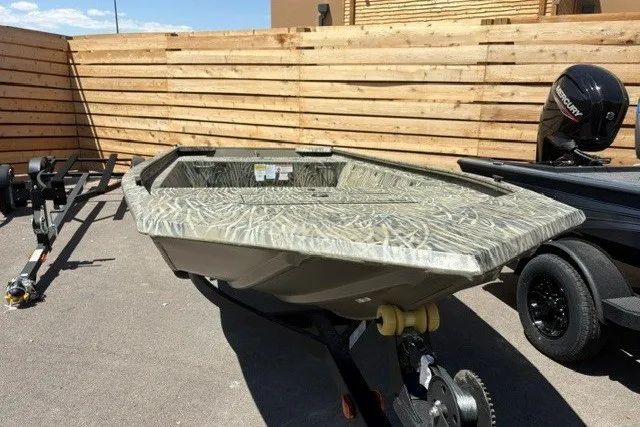 Slide: The Image of 2026 Tracker Grizzly 1648 Utility boat with camouflage design on a trailer. - 17