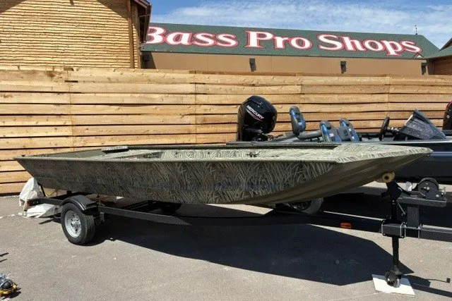 Slide: The Image of 2026 Tracker Grizzly 1648 Utility boat at Bass Pro Shops, parked on a trailer. - 16