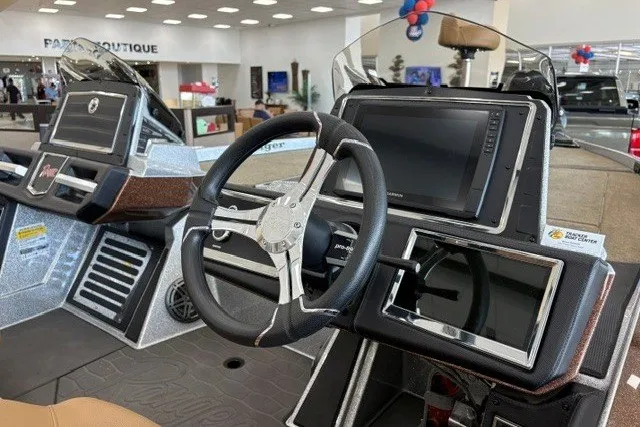 Slide: The Image of 2026 Ranger Z520R Cup-Equipped boat dashboard with steering wheel and digital displays. - 8