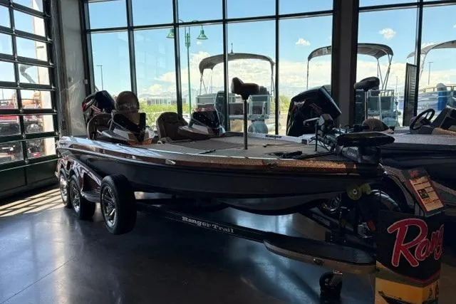 Slide: The Image of 2026 Ranger Z520R Cup-Equipped boat displayed indoors with large windows in the background. - 2