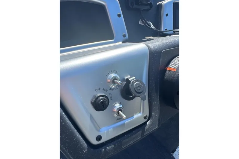 Slide: The Image of Dashboard controls of 2026 Tracker Pro Team 190 boat, featuring ignition and light switches. - 10