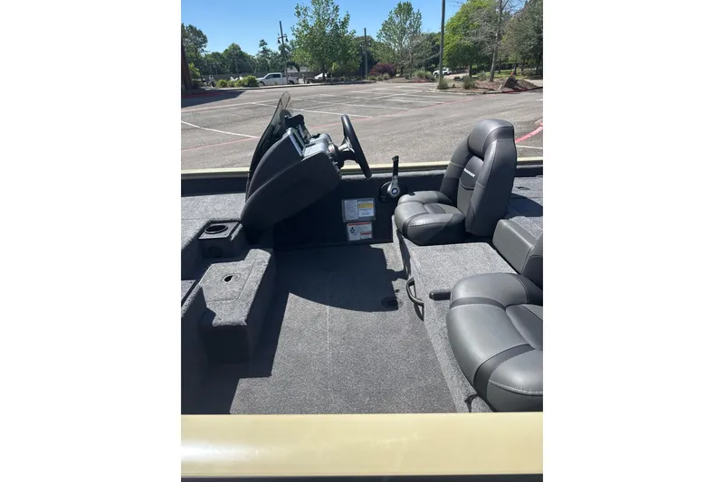 Slide: The Image of 2026 Tracker Pro Team 190 boat interior with gray seating and steering console. - 9