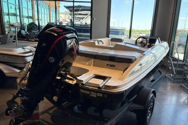 Slide: The Image of 2026 Tahoe T18 boat displayed indoors with powerful outboard motor. - 2