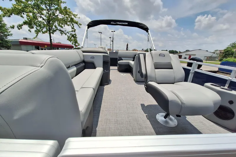 Slide: The Image of 2026 Sun Tracker SportFish 20 DLX pontoon boat interior with gray seating and open deck. - 4