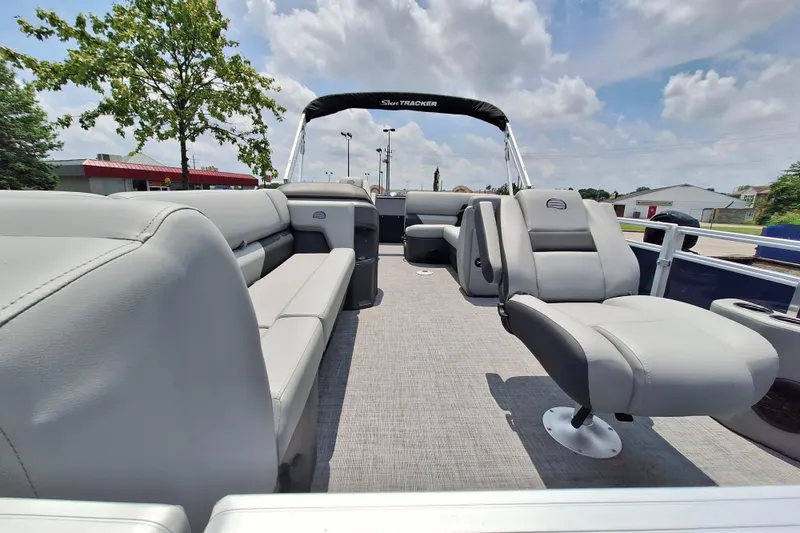 Slide: The Image of 2026 Sun Tracker SportFish 20 DLX pontoon boat interior with plush seating and open layout. - 1