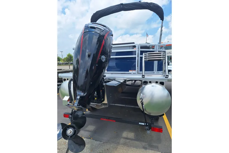 Slide: The Image of 2026 Sun Tracker SportFish 20 DLX pontoon boat with outboard motor, rear view. - 5