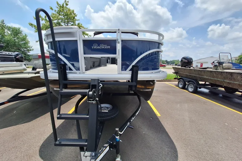 Slide: The Image of 2026 Sun Tracker SportFish 20 DLX pontoon boat on trailer in parking lot. - 3