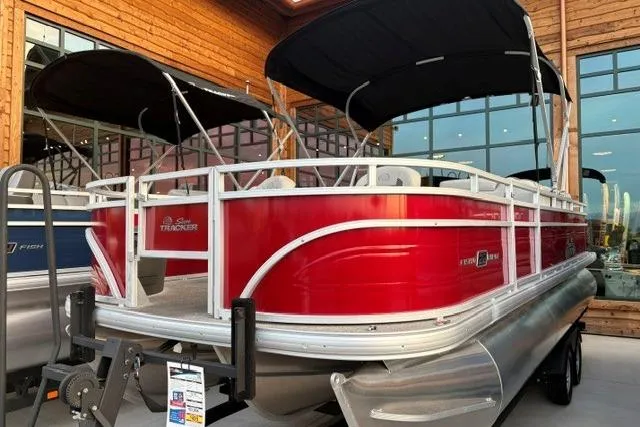The Image of 2026 Sun Tracker Fishin' Barge 22 XP3 pontoon boat with red exterior and black canopy. - 0