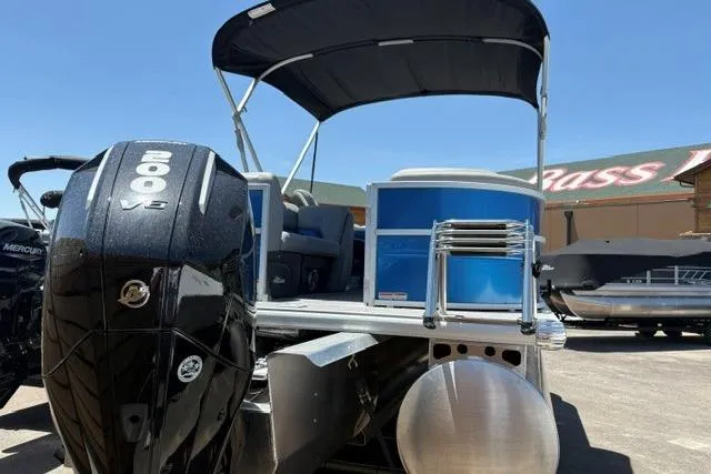 Slide: The Image of 2026 Sun Tracker Party Barge 22 XP3 pontoon boat with 200 HP engine, docked outdoors. - 1