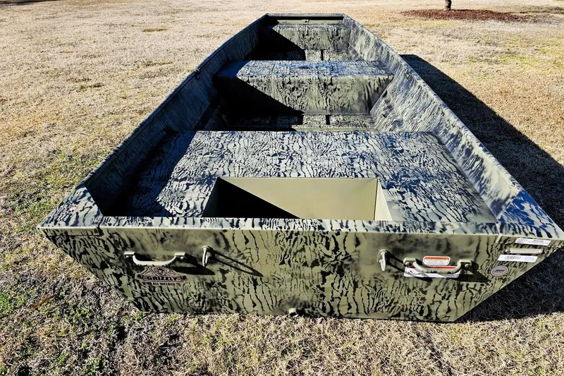 Slide: The Image of 2026 Tracker Grizzly 15 Jon boat with camouflage design on dry grass. - 8