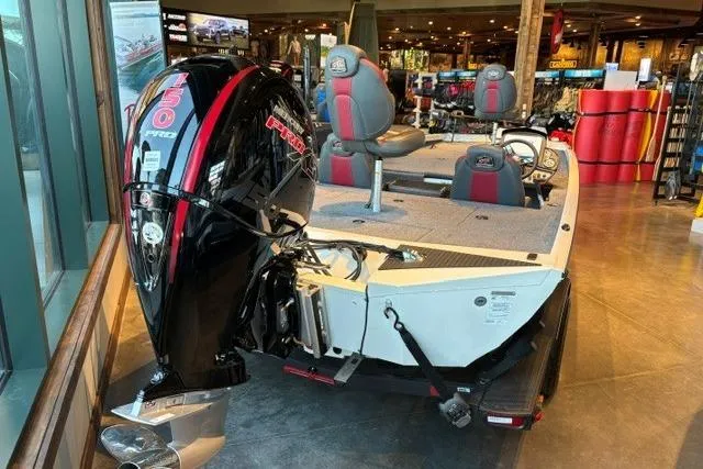 Slide: The Image of 2026 Ranger RT198P boat with powerful engine displayed indoors. - 2
