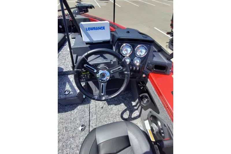 Slide: The Image of 2026 Tracker Targa V-18 Combo boat dashboard with steering wheel and gauges. - 2