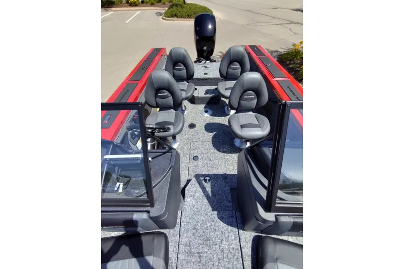 Slide: The Image of 2026 Tracker Targa V-18 Combo boat interior with four gray seats and red accents. - 3