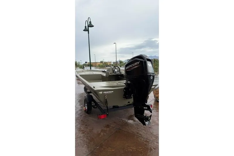 Slide: The Image of 2026 Tracker Grizzly 1648 SC boat with Mercury outboard motor on trailer. - 2