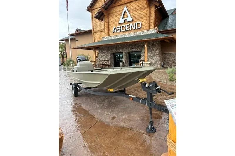 Slide: The Image of 2026 Tracker Grizzly 1648 SC boat on trailer outside Ascend store. - 3