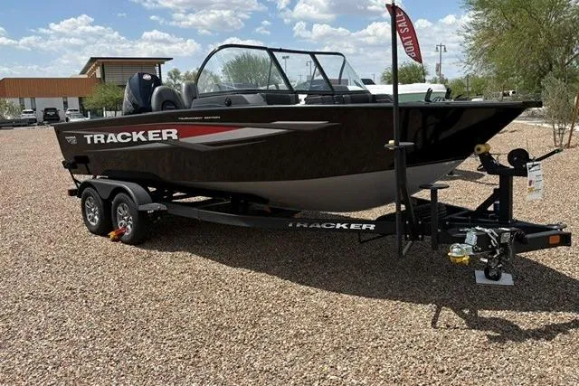 The Image of 2026 Tracker Targa V-19 Combo boat on trailer, parked on gravel under a sunny sky. - 0