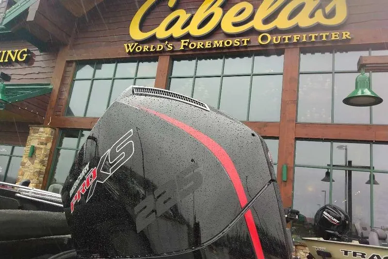 Slide: The Image of Nitro ZV19 Sport Pro 2026 boat engine outside Cabela's store in rainy weather. - 71