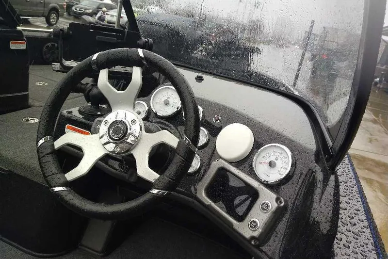 Slide: The Image of Steering wheel and dashboard of 2026 Nitro ZV19 Sport Pro boat in rainy weather. - 74