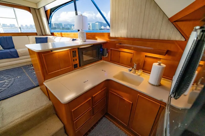 Slide: The Image of Luxurious 1998 Post 50 yacht kitchen with wood cabinetry and ocean view. - 13