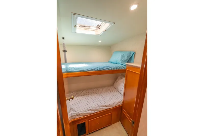 Slide: The Image of Bunk beds in a 1998 Post 50 yacht cabin with skylight and wooden finishes. - 15
