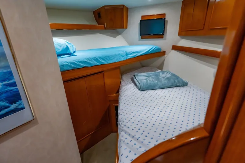 Slide: The Image of Cozy cabin interior with bunk beds and wooden cabinetry on a 1998 Post 50 yacht. - 17
