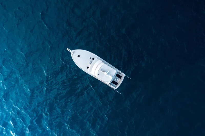 Slide: The Image of Aerial view of 1998 Post 50 yacht on deep blue ocean waters. - 23