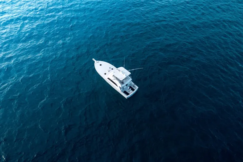 Slide: The Image of Aerial view of 1998 Post 50 yacht on deep blue ocean waters. - 24
