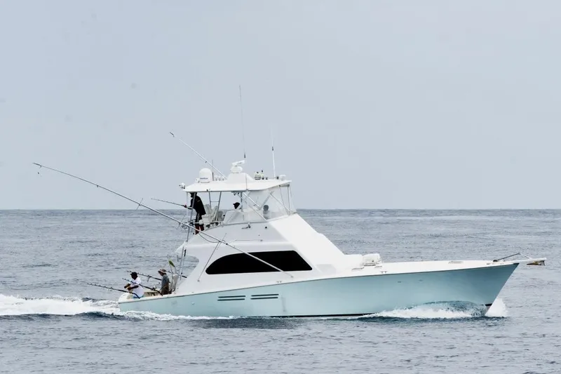 Slide: The Image of A 1998 Post 50 yacht cruising on open water with fishing rods. - 34